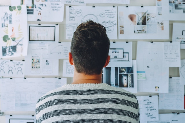 Man Standing In Front Of Board Planning How To Be A Landlord