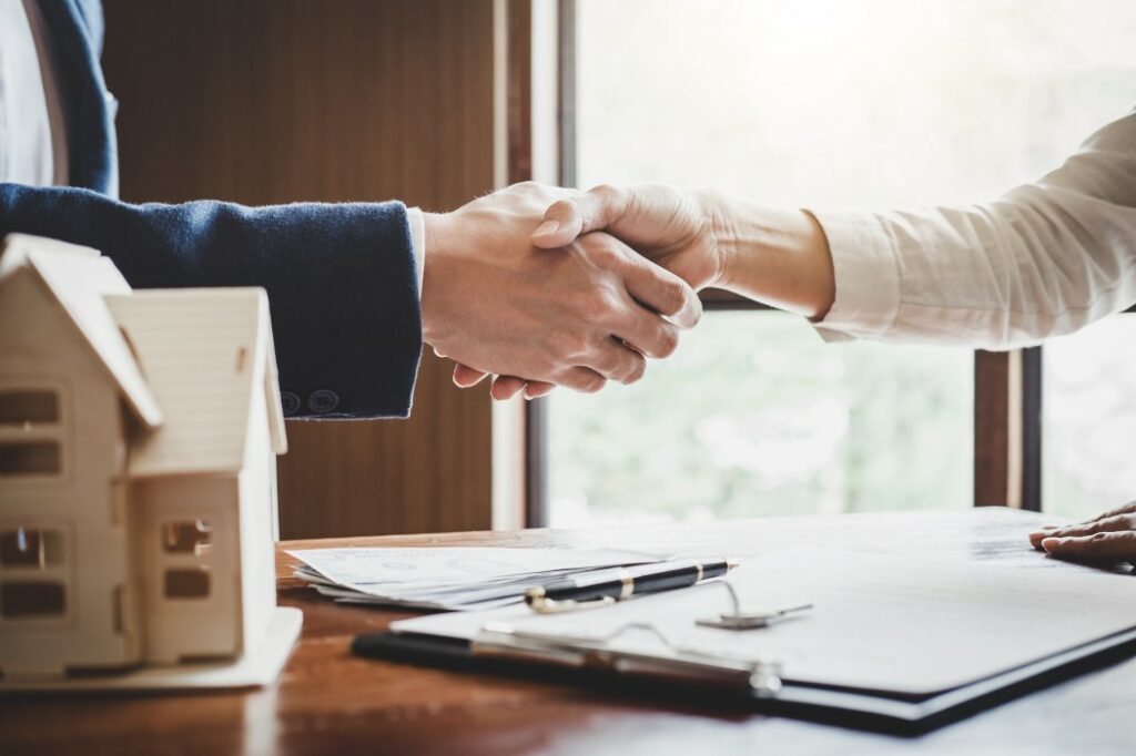 A Customer And Real Estate Agent Shaking Hands