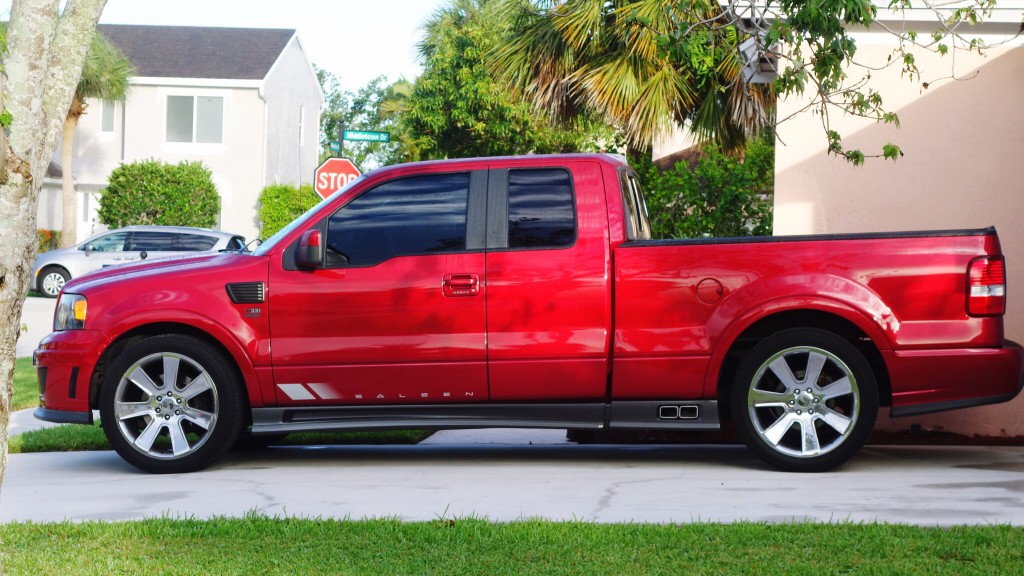 A Red Pick Up Truck Parked On A Driveway