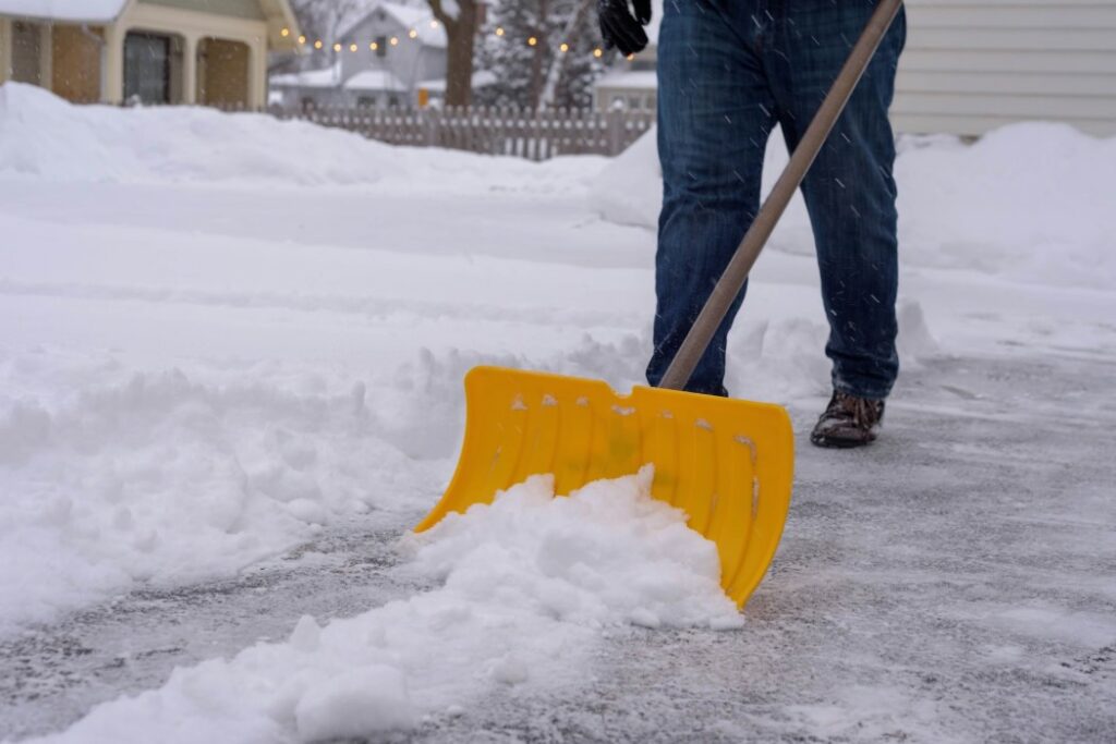 Someone Shovelling The Snow Of The Sidewalks For Article, Crazy Stories Of Homeowners Getting Sued