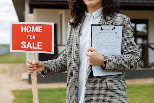 Woman Holding A Sale Sign